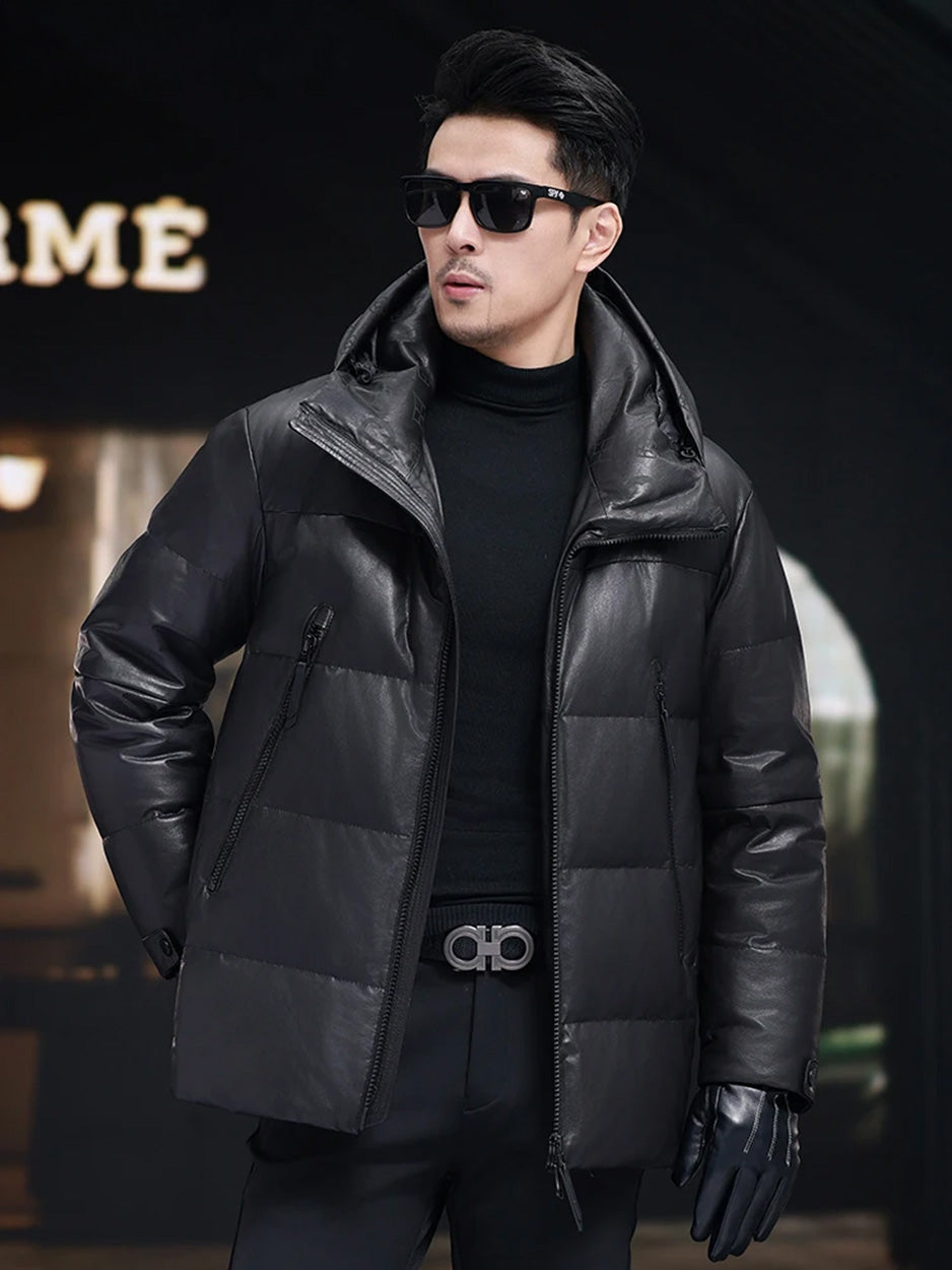 Model wearing men’s sheepskin jacket in Onyx, shown from the side with sculptural hood and large angled zippered pockets — From Borcelleclothes.