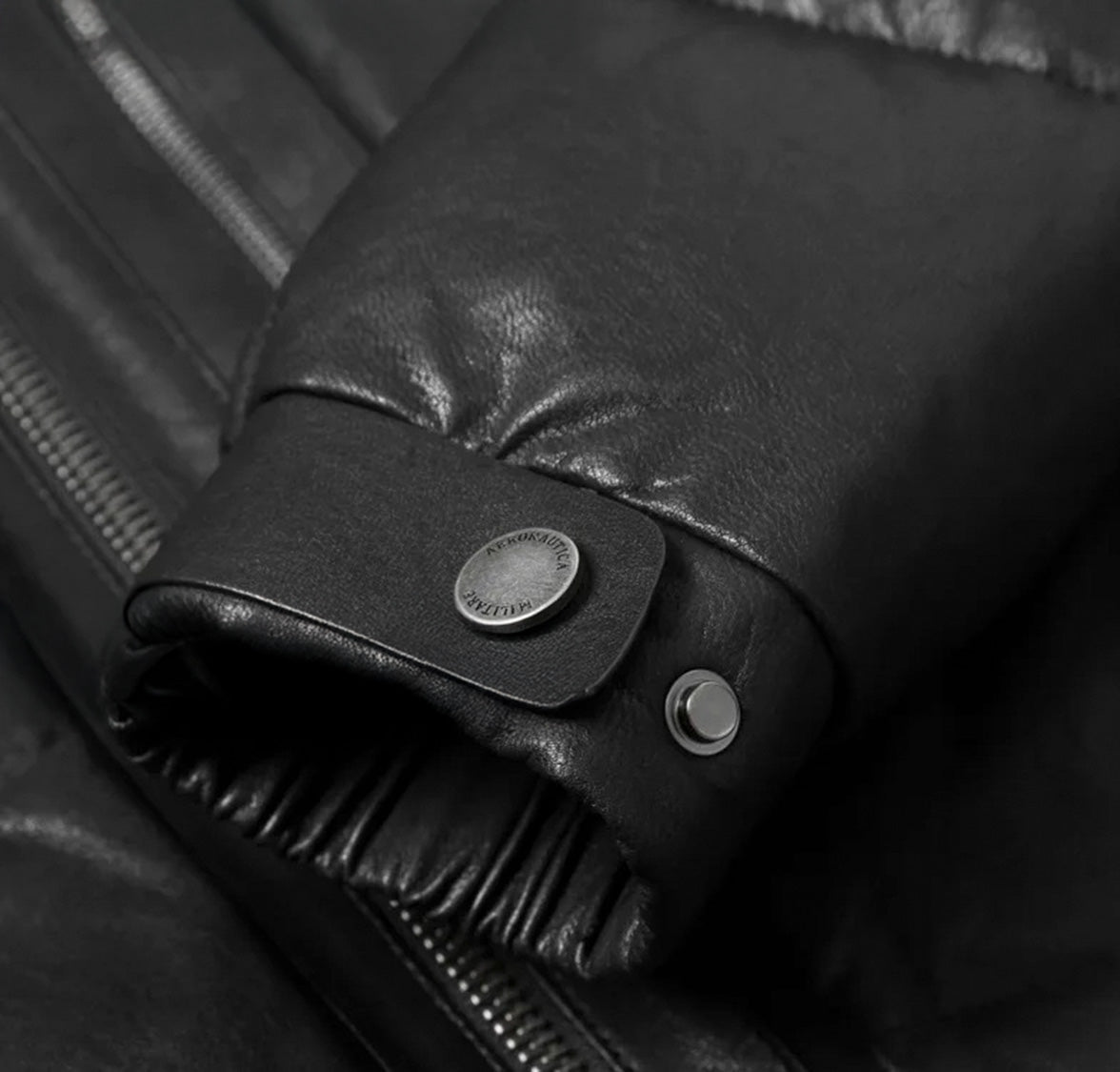 Elasticated cuff with strap and snap detail on Black Magic jacket – From Borcelleclothes.