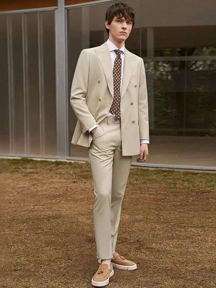 Model wearing a Soft Amber double-breasted suit with one hand in the pants pocket, conveying relaxed confidence. From Borcelleclothes.