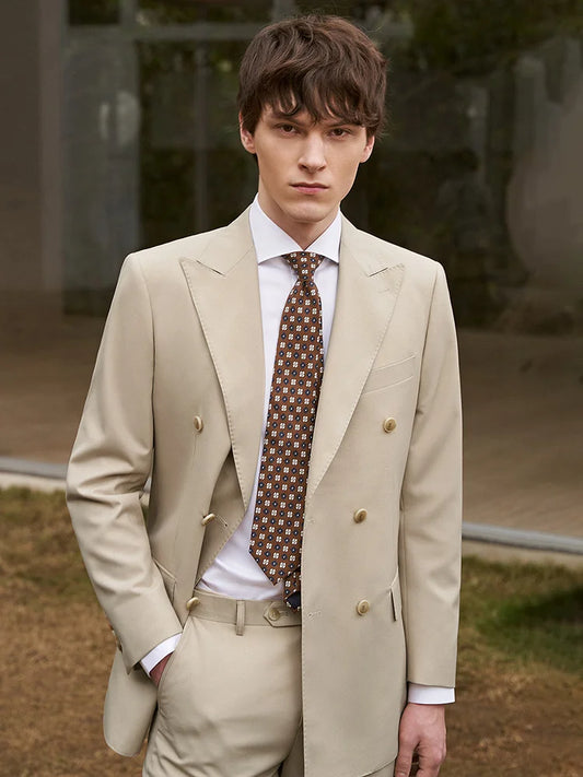 Men’s double-breasted suit in Soft Amber with peaked lapels and horn buttons, tailored for a composed, aristocratic presence. From Borcelleclothes.
