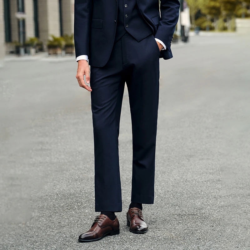 Men's Tailored cropped trousers in Blue Charcoal color with slim silhouette, clean hem, and discreet side adjusters. From Borcelleclothes.