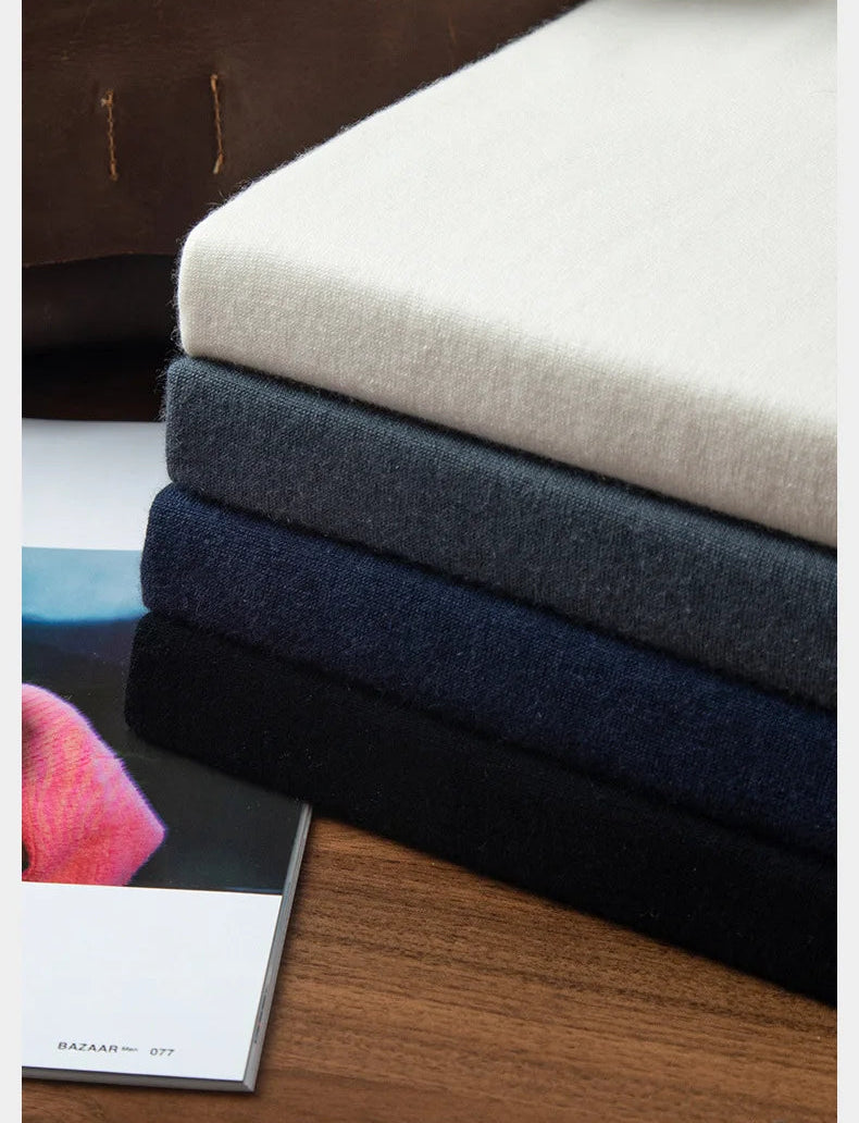 Stacked display of the men's worsted cashmere crewneck sweater in all available colors, showcasing the smooth finish of 100% Alashan cashmere — From Borcelleclothes.