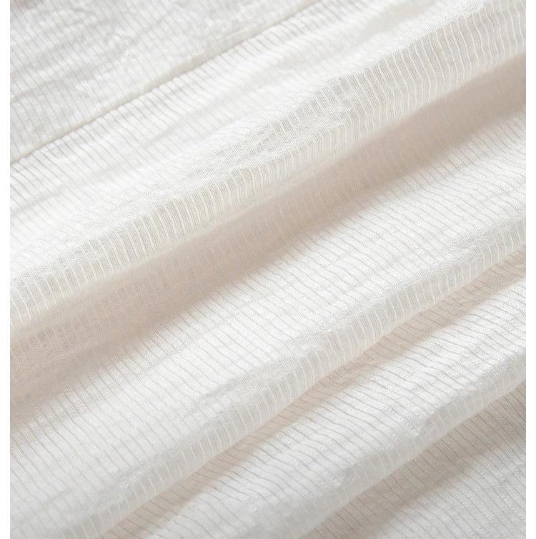 Close-up of pinstripe crinkle fabric in Pearl Bush with a wave-like folded texture. From Borcelleclothes.
