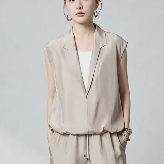 Video showcasing a Women's Habotai Mulberry silk blouse in Morning Draft and Blueprint. Featuring an elongated stepped shawl collar and a white tank top, joined at the elasticated hem. — From Borcelleclothes.