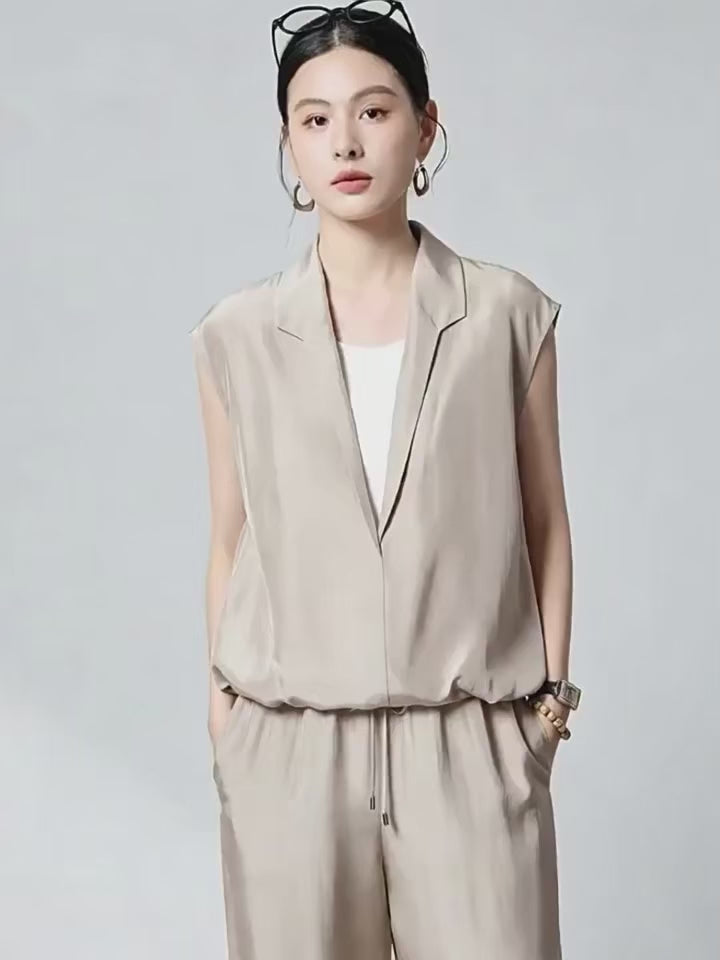 Video showcasing a Women's Habotai Mulberry silk blouse in Morning Draft and Blueprint. Featuring an elongated stepped shawl collar and a white tank top, joined at the elasticated hem. — From Borcelleclothes.