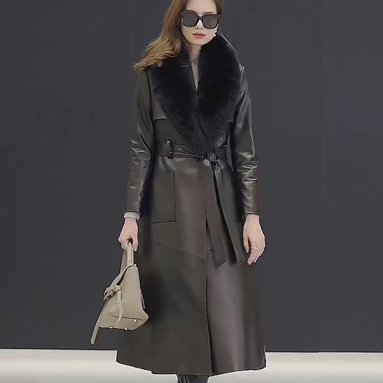 Video showcasing a Women's Leather Coat of Prestige in Nile Blue and Onyx. A mid-calf wrap coat crafted from sumptuous sheepskin, designed for effortless elegance and quiet confidence. Featuring a structured yet fluid silhouette, notch lapels, a detachable fox fur collar, and refined patch pockets. A statement of poise and authority. Borcelleclothes.