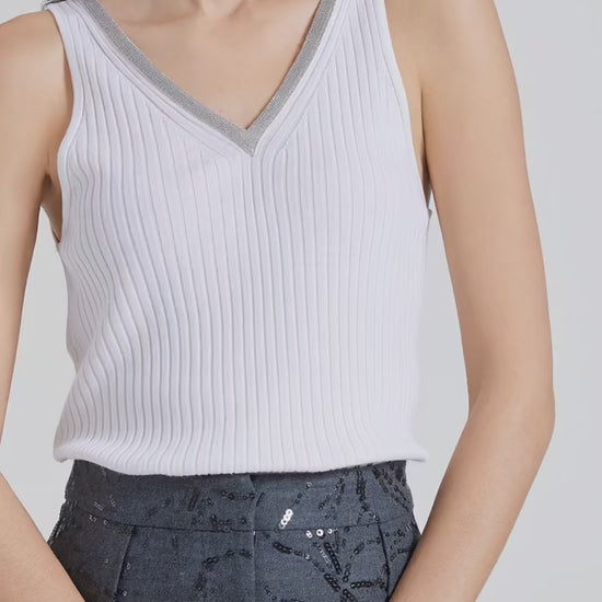 Video showcasing a Women’s slim-fit wide-rib wool and silk top in White Lilac with front and back V-necklines and delicate rhinestone fringe at the front. From Borcelleclothes.