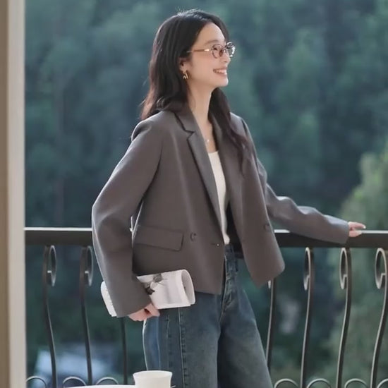 Video showcasing a Women's Davy Grey double-breasted blazer with shortened silhouette, notch lapels, and flap pockets. From Borcelleclothes.