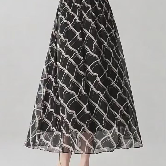 Video showcasing a 6A Grade Mulberry silk midi skirt in Café Mirage and Night Hallucination, featuring an immersive 3D geometric print and a comfortable knit-rib waistband. — From Borcelleclothes.
