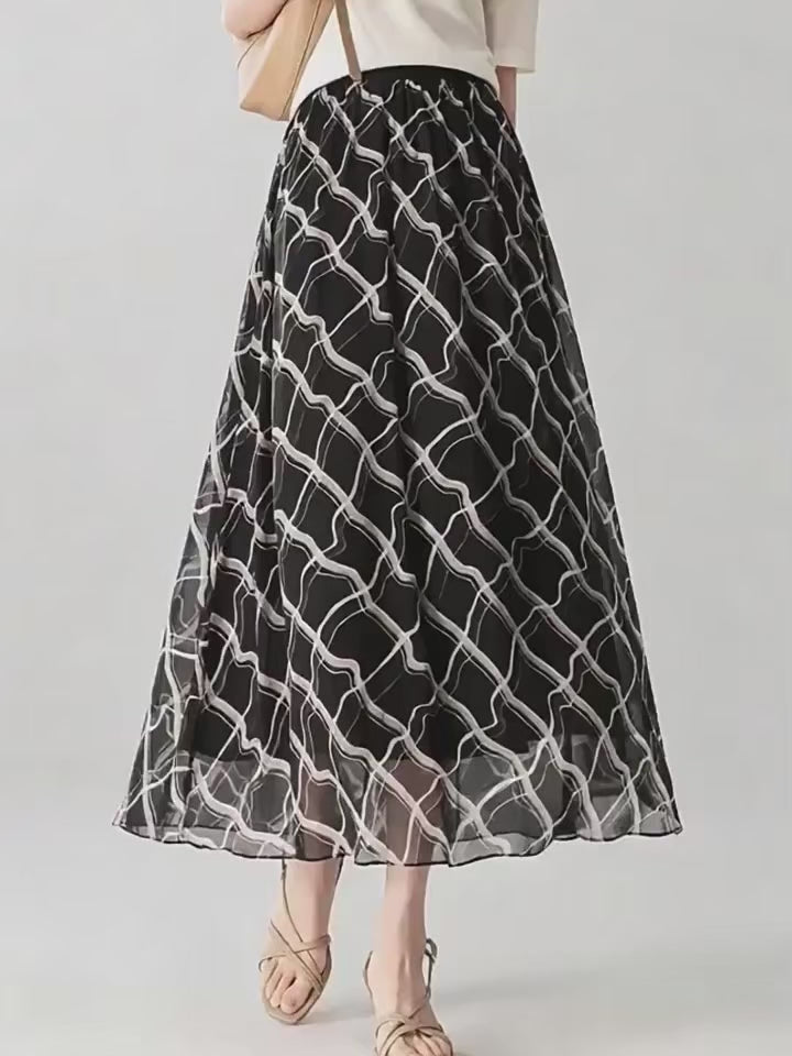 Video showcasing a 6A Grade Mulberry silk midi skirt in Café Mirage and Night Hallucination, featuring an immersive 3D geometric print and a comfortable knit-rib waistband. — From Borcelleclothes.