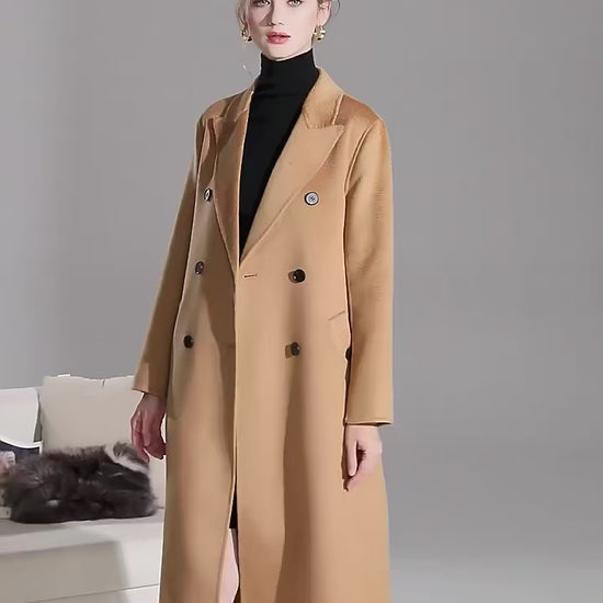 Video showcasing a Women's Double-Sided Wool-Cashmere Coat in Brown Sugar and Bourbon, showcasing luxurious peaked lapels, a straight silhouette, and meticulously tailored details like single-welt pockets with buttonholes, crafted from a premium wool-cashmere blend for warmth and refinement. From Borcelleclothes.