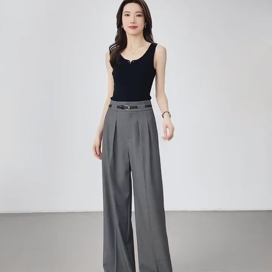 Video showcasing Women's tailored trousers in Storm Dust, featuring partial waistband casings and deep front pleats for a structured yet fluid silhouette. From Borcelleclothes.