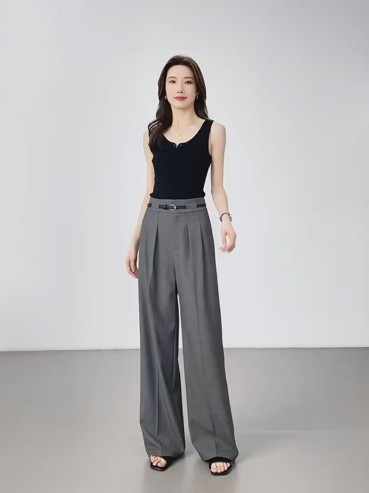 Video showcasing Women's tailored trousers in Storm Dust, featuring partial waistband casings and deep front pleats for a structured yet fluid silhouette. From Borcelleclothes.