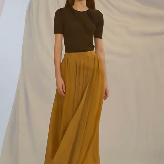 Video showcasing a Women's luxury golden-mustard silk wrap midi skirt with structured panels, delicate pintuck details, and flowing georgette hem. — From Borcelleclothes.