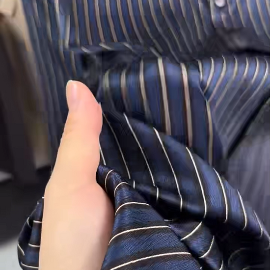 Video showcasing a Men's regular-fit luxury shirt in Burning the Midnight Oil and inky Prose colors, featuring a vertical stripe pattern over a textured herringbone weave, made from a Mulberry silk-spandex blend. — From Borcelleclothes.