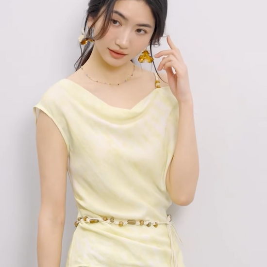 Video showcasing a Women's Urban Hippolita set: golden viscose top with beaded shoulder strap and cowl neck, asymmetrical hem, and flared midi skirt with decorative beaded belt. — From Borcelleclothes.