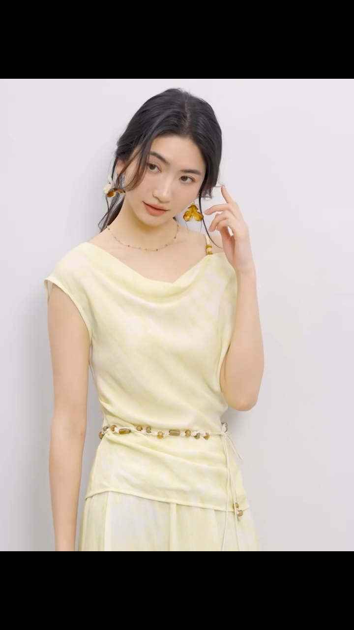 Video showcasing a Women's Urban Hippolita set: golden viscose top with beaded shoulder strap and cowl neck, asymmetrical hem, and flared midi skirt with decorative beaded belt. — From Borcelleclothes.