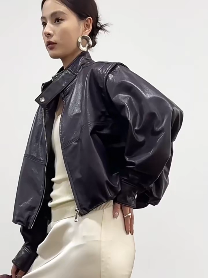 Video showcasing a Women's waxed full-grain sheepskin jacket in Without Label. Features a domed silhouette, deep-cut armscyes, and detachable batwing sleeves converting into a vest. — From Borcelleclothes.