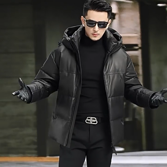 Video showcasing a Men’s goose down jacket in matte cowhide leather with a sculpted stand collar integrated into the hood, vertical side zip pockets, and diagonal embossed leather insets — From Borcelleclothes.