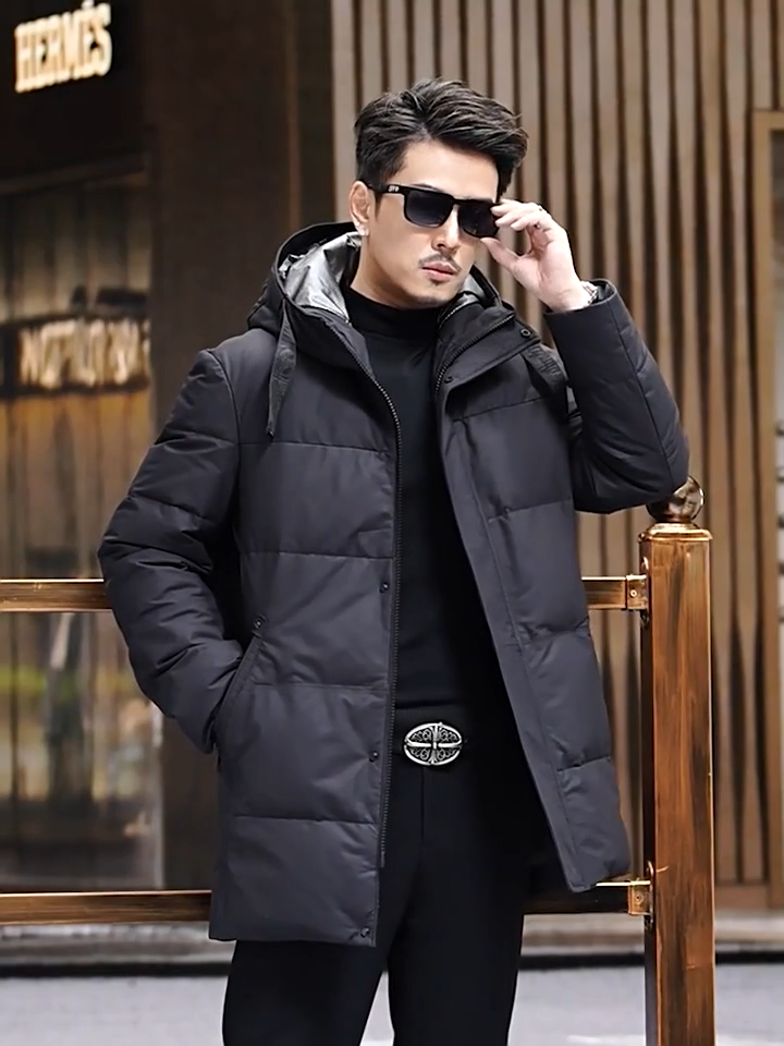 Video showcasing a Men's Matte cowhide down coat in Abyss, featuring  a wide hood belt, reflective lining, and concealed placket. From Borcelleclothes.