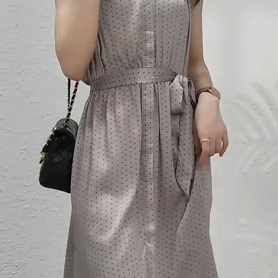 Video showcasing a Mulberry silk polka dot dress in Almond Frost with a soft V-neckline, decorative placket, and gently flared skirt—draped with quiet elegance. From Borcelleclothes.