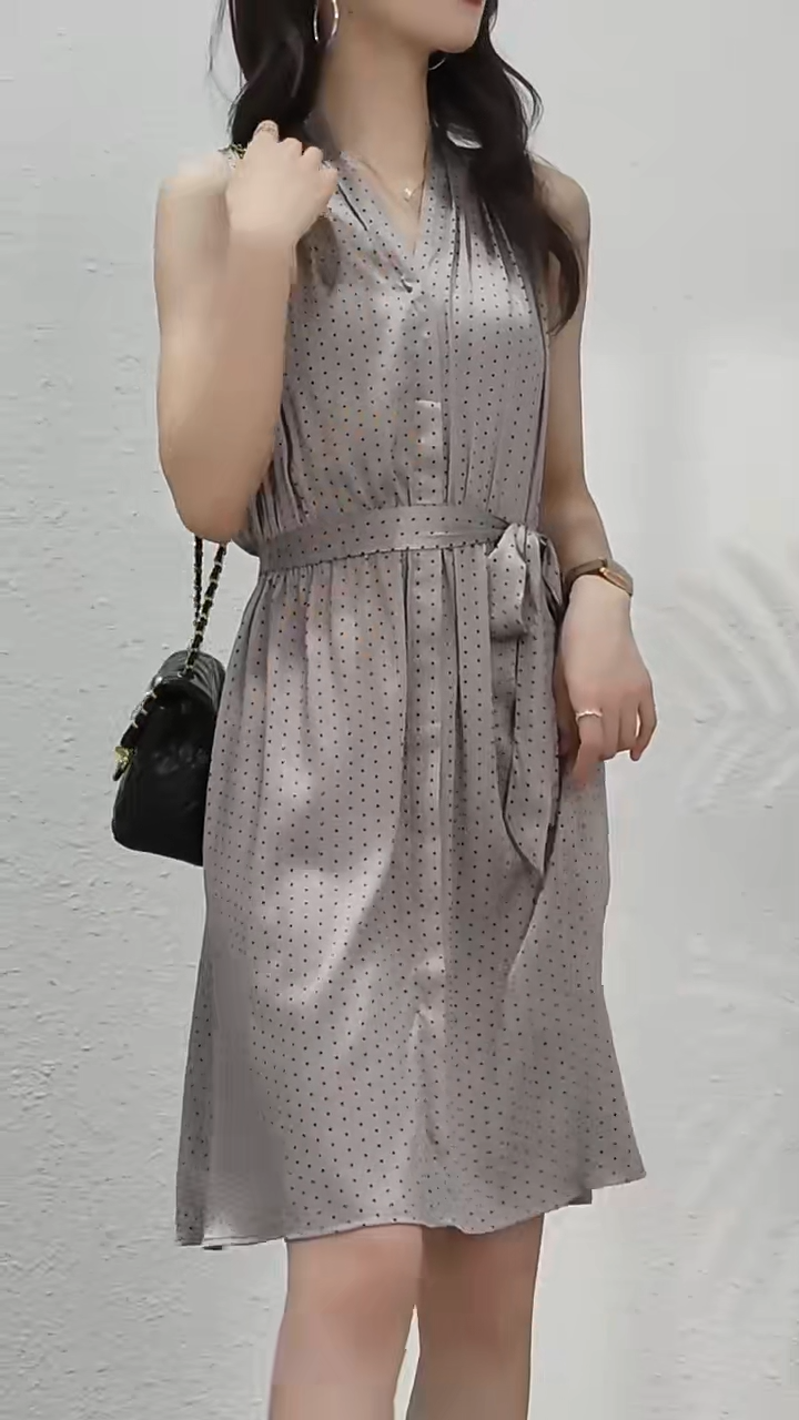 Video showcasing a Mulberry silk polka dot dress in Almond Frost with a soft V-neckline, decorative placket, and gently flared skirt—draped with quiet elegance. From Borcelleclothes.