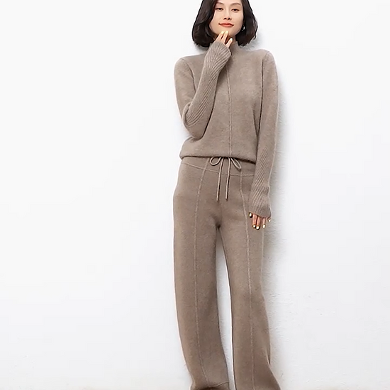 Video showcasing a Women's Traced Seaming Cashmere Trousers in Almond Frost, with traced seaming, yoke-inspired accents, and ribbed waistband with drawstring — From Borcelleclothes.