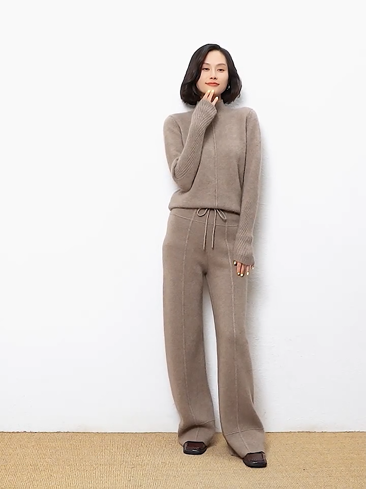 Video showcasing a Women's Traced Seaming Cashmere Trousers in Almond Frost, with traced seaming, yoke-inspired accents, and ribbed waistband with drawstring — From Borcelleclothes.