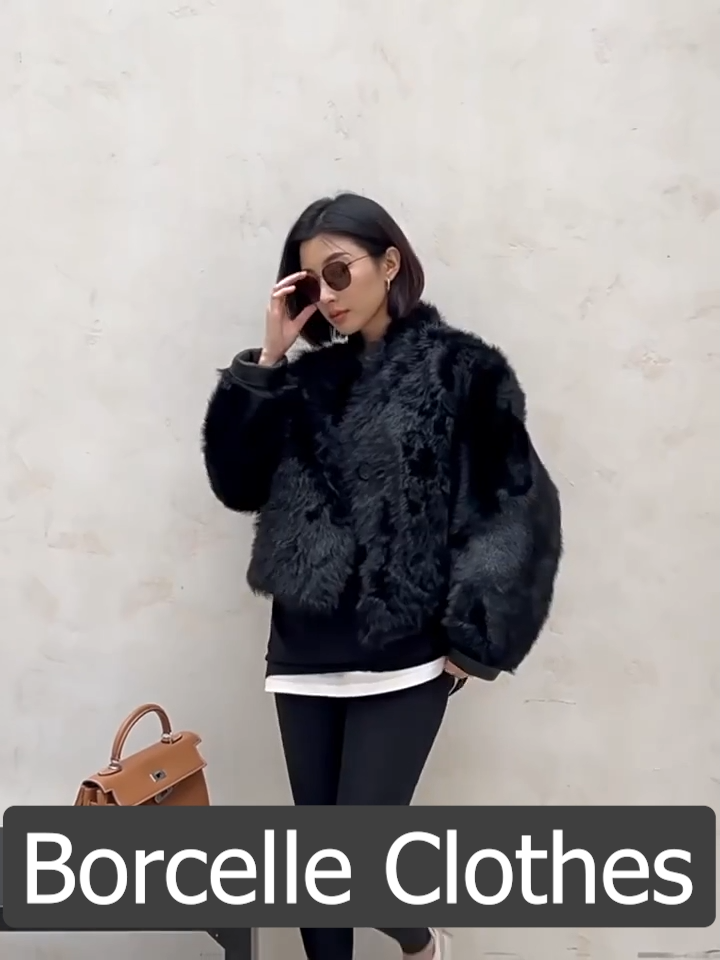 Video showcasing a Women's Reversible cropped shearling jacket in Autographe, featuring a cut-on collar with shoulder darts, softly curled wool, and a dense, inky surface — From Borcelleclothes.