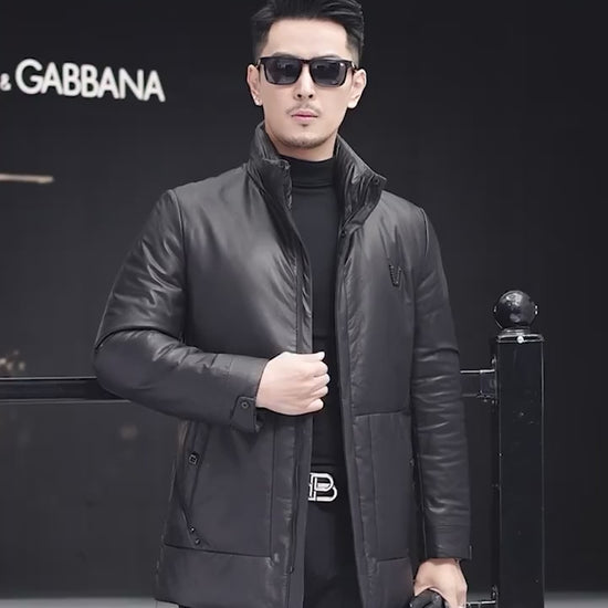 Video showcasing a Men’s cowhide leather down jacket in Onyx with set-in oversized pockets, grosgrain ribbon inserts, and decorative “V” badge — From Borcelleclothes.