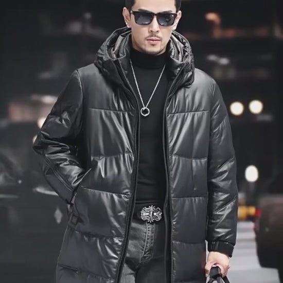 Video showcasing a Men’s leather down coat in Onyx — featuring a sculpted stand collar integrated into a hood, side zip pockets, and matte metal-detailed cuffs. From Borcelleclothes.