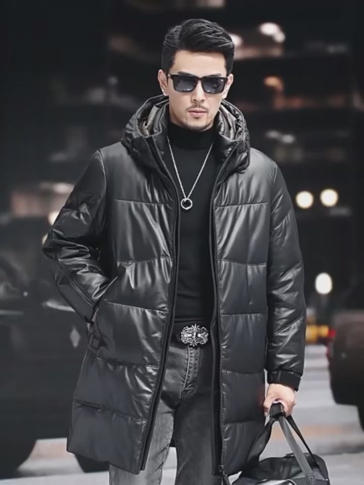 Video showcasing a Men’s leather down coat in Onyx — featuring a sculpted stand collar integrated into a hood, side zip pockets, and matte metal-detailed cuffs. From Borcelleclothes.