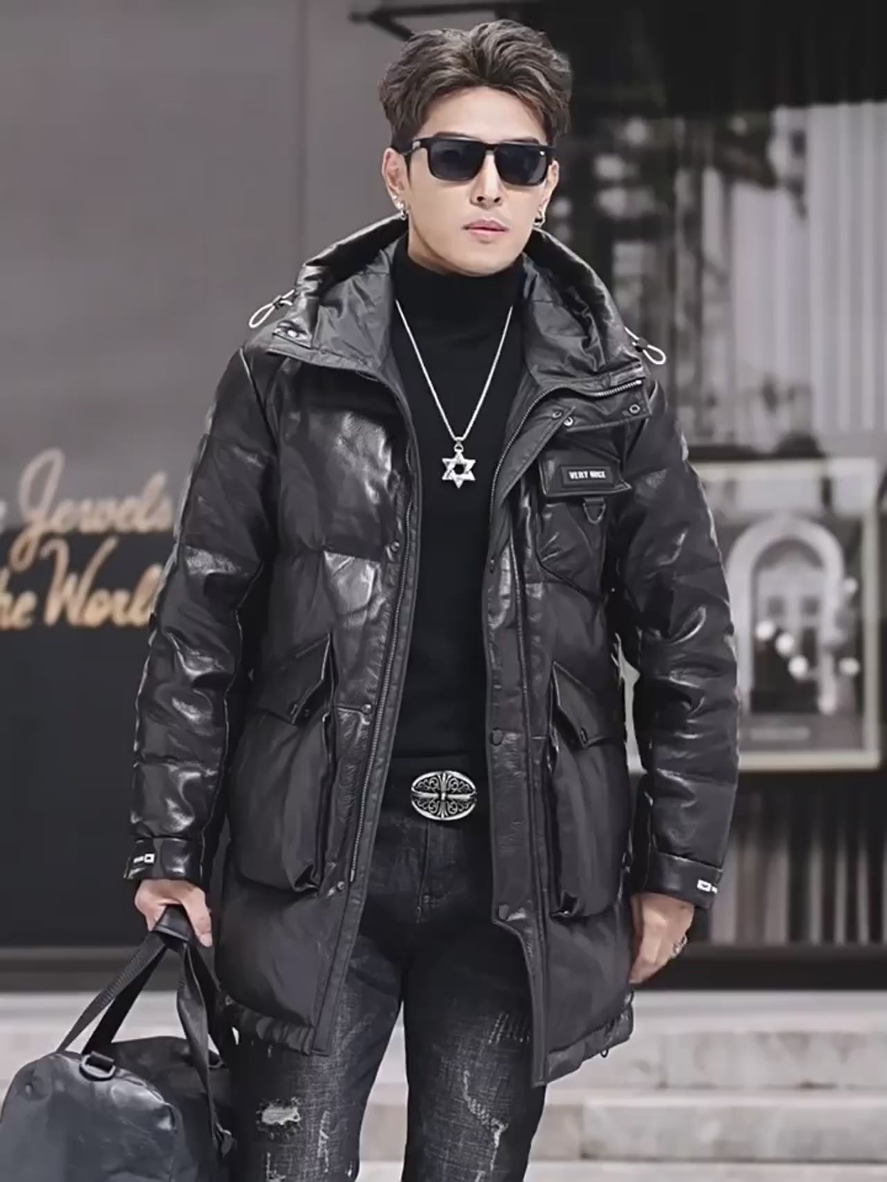 Video showcasing a Men's sheepskin gloss down jacket in Onyx, mid-thigh length with curved placket, reflective surface, and soft silhouette. From Borcelleclothes.