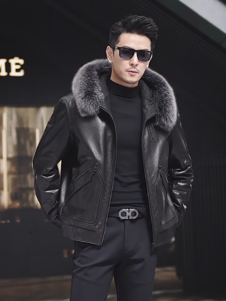 Video showcasing a Men’s cowhide leather coat in Onyx with detachable fox fur hood trim, piped curved pockets, badge detail, and snap cuffs. — From Borcelleclothes.