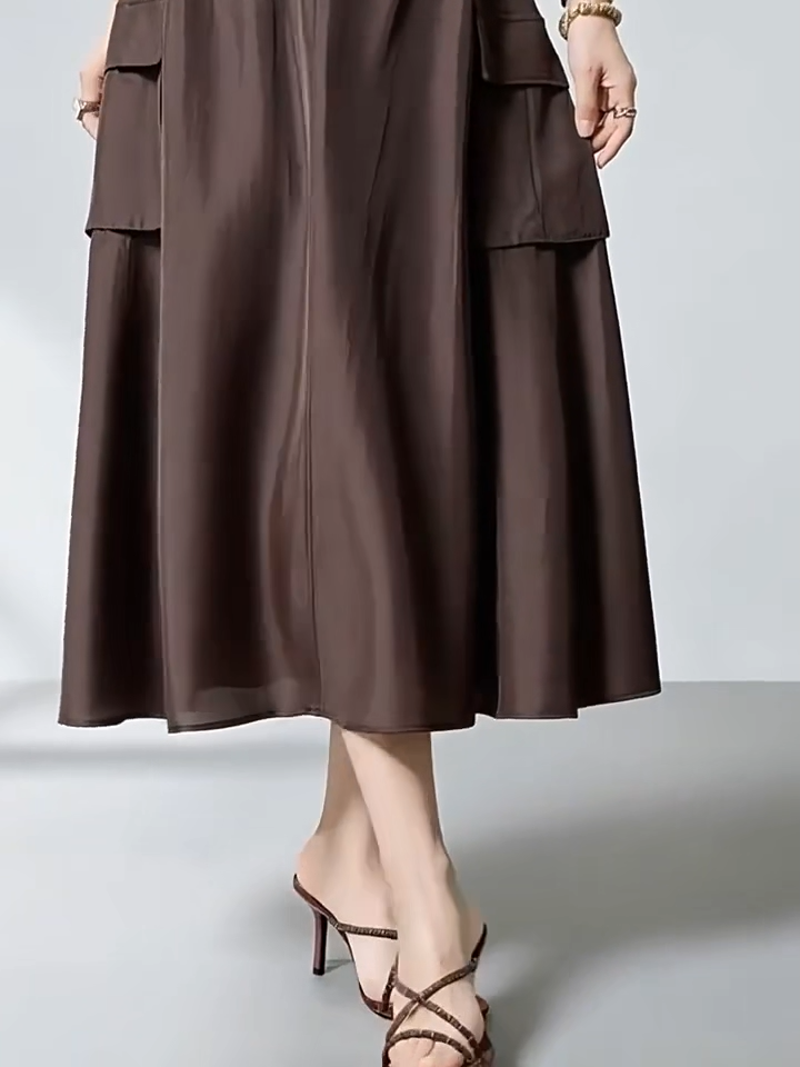 Video showcasing a Women's flared midi cargo skirt crafted from premium Grade 6A Mulberry silk poplin in Bitter Chocolate. Features structured panel seam pockets and an elasticated back. — From Borcelleclothes.