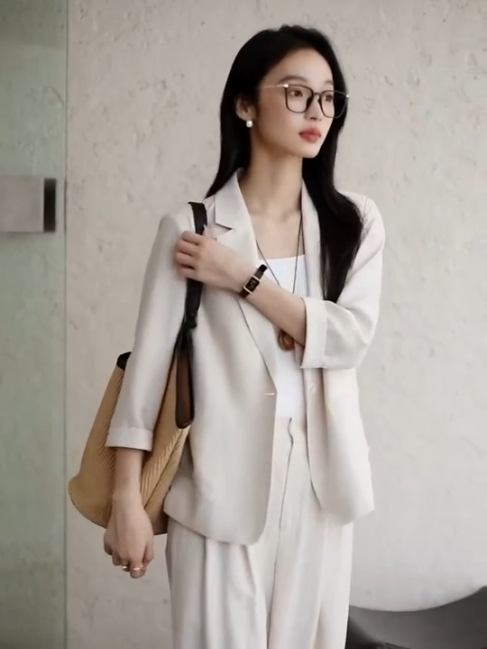 Video showcasing a Women's two-piece set in an undefined neutral shade Bon Jour, featuring a relaxed silhouette and minimalist tailoring that reflect quiet urban elegance. From Borcelleclothes.