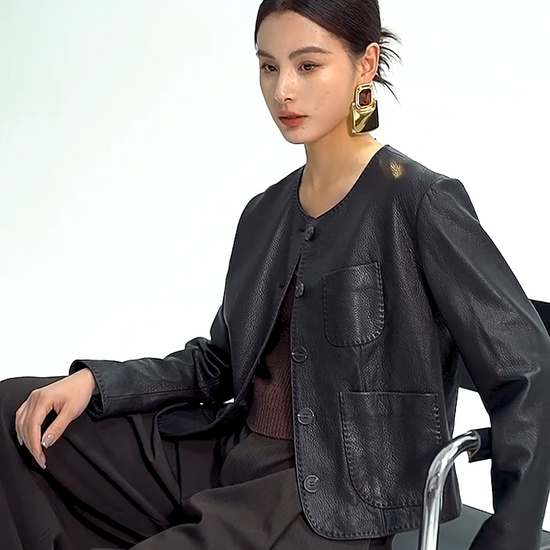 Video showcasing a Women's Cropped jacket in drum-milled goatskin leather, shade Calculated Tension. Defined by natural pebbled grain and heavy-gauge double topstitching along the edges. — From Borcelleclothes.