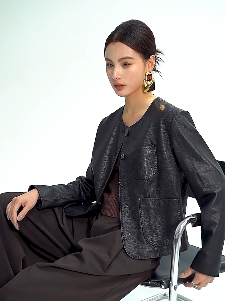 Video showcasing a Women's Cropped jacket in drum-milled goatskin leather, shade Calculated Tension. Defined by natural pebbled grain and heavy-gauge double topstitching along the edges. — From Borcelleclothes.