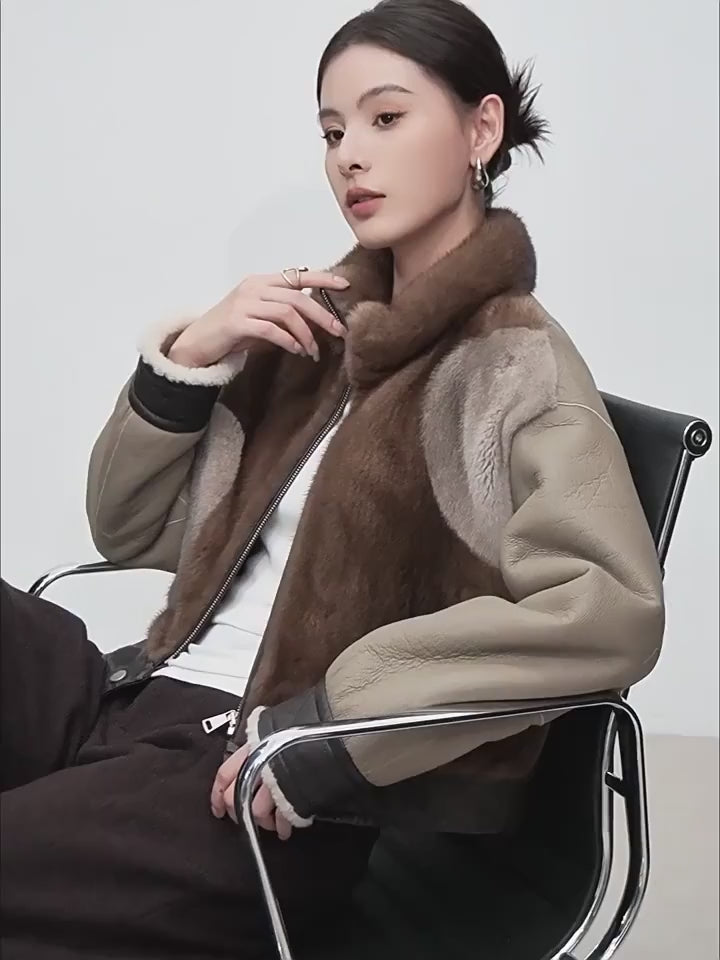 Video showcasing a Women’s cropped jacket in Cardamon Spice, combining real mink and genuine shearling, featuring asymmetrical patchwork and quilted leather accents. — From Borcelleclothes.