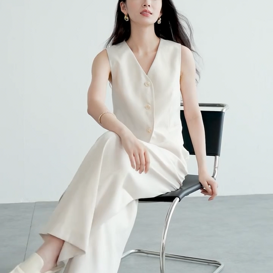 Video showcasing a Women's two-piece linen blend set in C’est Ça color. Mid-waist trousers with crossed pleats, tailored V-neck vest with tone-on-tone buttons. — From Borcelleclothes.