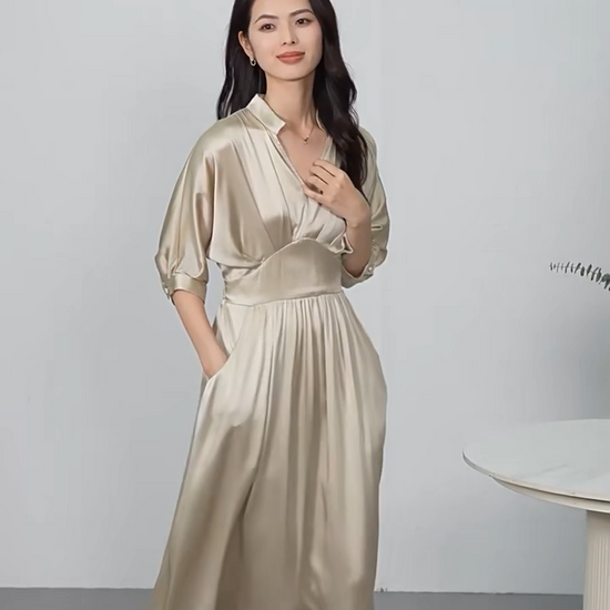 Video showcasing a midi-length Mulberry silk satin dress in Taste of Champagne and Hot Ice colors, with a stand-up collar, V-neckline, and elegant pleated waist detail. — From Borcelleclothes.