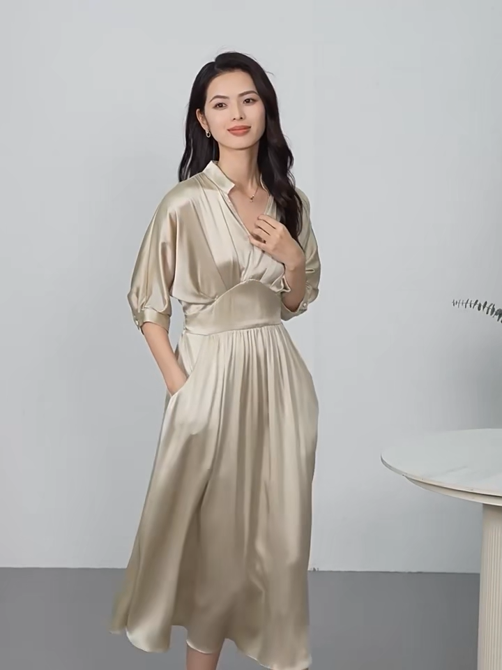 Video showcasing a midi-length Mulberry silk satin dress in Taste of Champagne and Hot Ice colors, with a stand-up collar, V-neckline, and elegant pleated waist detail. — From Borcelleclothes.