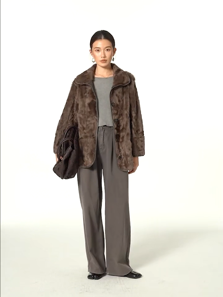 Video showcasing a Women's reversible lake-region shearling coat in Clove Ripples, featuring a double-faced collar and horn buttons — From Borcelleclothes.