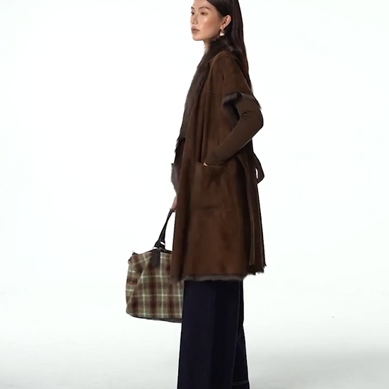 Video showcasing a Women’s kimono-sleeve goatskin jacket in Coffeehouse Chocolate, wrap design with self-tie belt and shawl collar revealing natural fur — From Borcelleclothes.