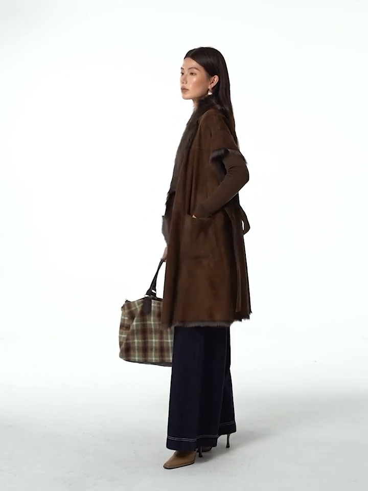 Video showcasing a Women’s kimono-sleeve goatskin jacket in Coffeehouse Chocolate, wrap design with self-tie belt and shawl collar revealing natural fur — From Borcelleclothes.