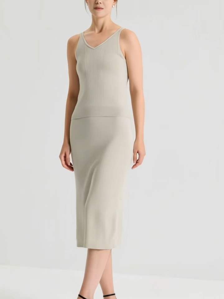 Video showcasing a Women's sculptural midi skirt in rib wool-silk blend with a discreet side slit. Straight silhouette in Compliant Sage and Silent Adept hues. — From Borcelleclothes.