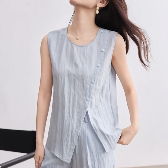 Video showcasing a Women's light blue asymmetrical wrap top and matching wide-leg pleated trousers in a crinkled linen-lyocell blend. — From Borcelleclothes.