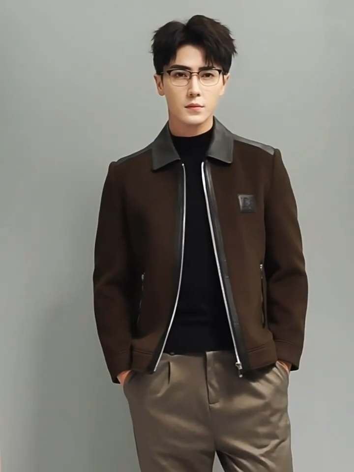 Video showcasing a Men’s structured leather-wool jacket in Dark Rum, featuring a leather collar, shoulders, and back with soft wool panels, finished with cuffs and a lower band for a defined silhouette. From Borcelleclothes.