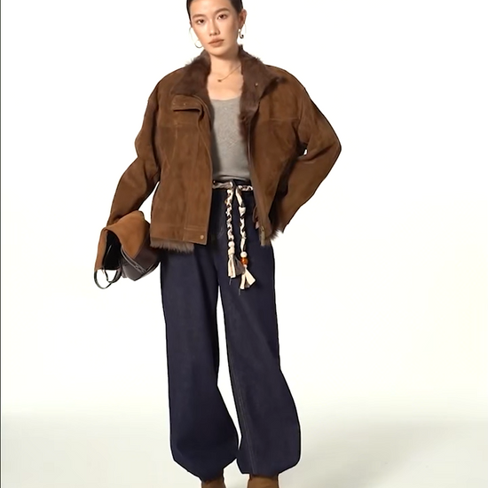 Video showcasing a Women's dropped-shoulder Goatskin jacket in Dark Rum, with exposed fur trims, suede finish, and turn-back cuffs. — From Borcelleclothes.