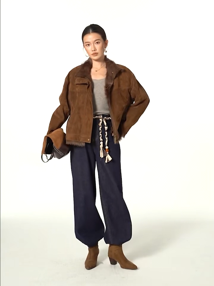 Video showcasing a Women's dropped-shoulder Goatskin jacket in Dark Rum, with exposed fur trims, suede finish, and turn-back cuffs. — From Borcelleclothes.